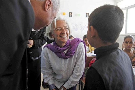 Christine Lagarde (C), International Monetary Fund Managing Director, speaks to a Syrian refugee student at Alimate school in Mafraq in this Christine Lagarde (C), International Monetary Fund Managing Director, speaks to a Syrian refugee student at Alimate school in Mafraq in this