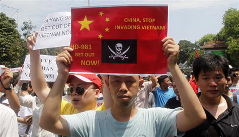Protesters hold anti-China placards while marching in an anti-China protest on a street in Hanoi May 11, 2014. REUTERS/Kham Protesters hold anti-China placards while marching in an anti-China protest on a street in Hanoi May 11, 2014. REUTERS/Kham