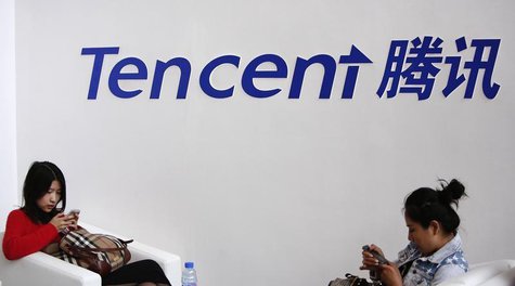 Visitors use their smarts phones underneath the logo of Tencent at the Global Mobile Internet Conference in Beijing May 6, 2014. REUTERS/Kim Visitors use their smarts phones underneath the logo of Tencent at the Global Mobile Internet Conference in Beijing May 6, 2014. REUTERS/Kim