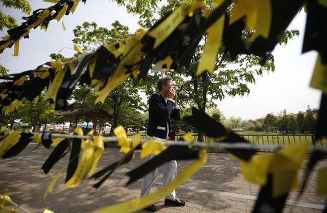 A mourner cries next to yellow ribbons dedicated to missing and dead passengers of sunken passenger ship Sewol, after paying tribute at the A mourner cries next to yellow ribbons dedicated to missing and dead passengers of sunken passenger ship Sewol, after paying tribute at the