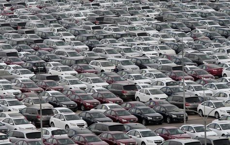 An employee yawns as he walks among General Motors' new Chinese-made cars at a parking lot in Shenyang, Liaoning province April 21, 2014. RE An employee yawns as he walks among General Motors' new Chinese-made cars at a parking lot in Shenyang, Liaoning province April 21, 2014. RE