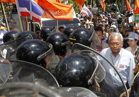 Anti-government protest leader Suthep Thaugsuban walks past Air Force military personnel during a rally at the Air Force base in Bangkok May Anti-government protest leader Suthep Thaugsuban walks past Air Force military personnel during a rally at the Air Force base in Bangkok May