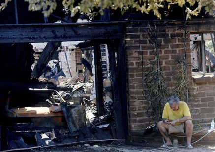 Greg Saska surveys the damage to his home after it was destroyed during the Poinsettia Fire in Carlsbad, California May 15, 2014. REUTERS/Sa Greg Saska surveys the damage to his home after it was destroyed during the Poinsettia Fire in Carlsbad, California May 15, 2014. REUTERS/Sa