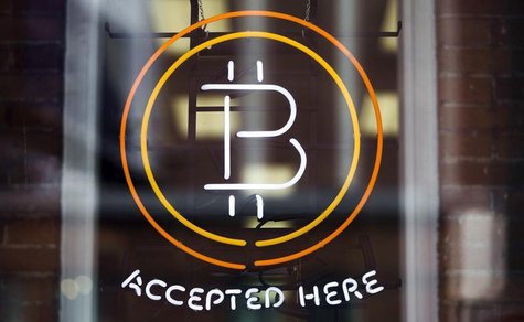 A Bitcoin sign is seen in a window in Toronto, May 8, 2014. REUTERS/Mark Blinch A Bitcoin sign is seen in a window in Toronto, May 8, 2014. REUTERS/Mark Blinch
