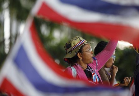 An anti-government protester blows her whistle during a rally outside the office of Election Commission in Bangkok May 15, 2014. REUTERS/Cha An anti-government protester blows her whistle during a rally outside the office of Election Commission in Bangkok May 15, 2014. REUTERS/Cha
