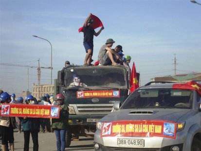 Protesters display banners which read, "Paracels and Spratlys belong to Vietnam", outside the construction site of a Formosa steel mill in H Protesters display banners which read, "Paracels and Spratlys belong to Vietnam", outside the construction site of a Formosa steel mill in H