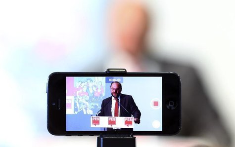 A journalist records the speech of Socialist candidate for European Commission president, Martin Schulz, with his mobile phone during a news A journalist records the speech of Socialist candidate for European Commission president, Martin Schulz, with his mobile phone during a news