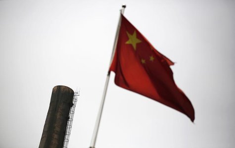 A Chinese national flag is seen in front of a chimney of a heat supply plant in Beijing May 13, 2014. REUTERS/Kim Kyung-Hoon A Chinese national flag is seen in front of a chimney of a heat supply plant in Beijing May 13, 2014. REUTERS/Kim Kyung-Hoon