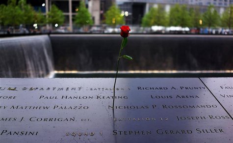 A rose is placed on a name engraved along the South reflecting pool at the Ground Zero memorial site during the dedication ceremony of the N A rose is placed on a name engraved along the South reflecting pool at the Ground Zero memorial site during the dedication ceremony of the N