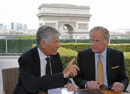 Maurice Levy (L), French advertising group Publicis Chief executive, and John Wren, head of Omnicom Group, gesture during a joint signature Maurice Levy (L), French advertising group Publicis Chief executive, and John Wren, head of Omnicom Group, gesture during a joint signature