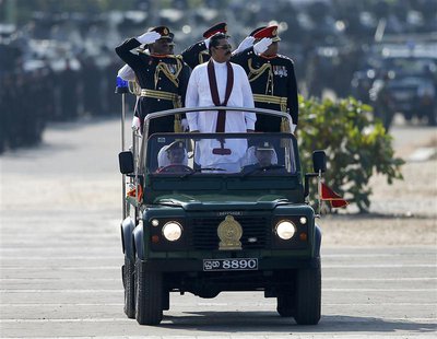 Sri Lanka's President Mahinda Rajapaksa (in white) takes part in a War Victory parade in Matara May 18, 2014. REUTERS/Dinuka Liyanawatte Sri Lanka's President Mahinda Rajapaksa (in white) takes part in a War Victory parade in Matara May 18, 2014. REUTERS/Dinuka Liyanawatte