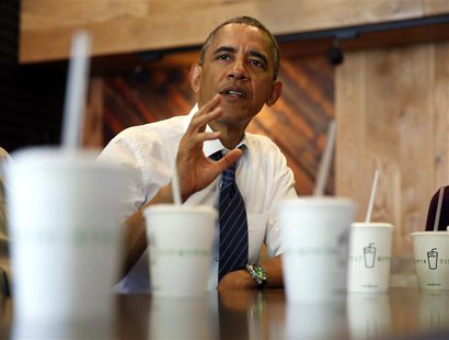 U.S. President Barack Obama talks while having lunch with construction workers at Shake Shack in Washington May 16, 2014. REUTERS/Kevin Lama U.S. President Barack Obama talks while having lunch with construction workers at Shake Shack in Washington May 16, 2014. REUTERS/Kevin Lama