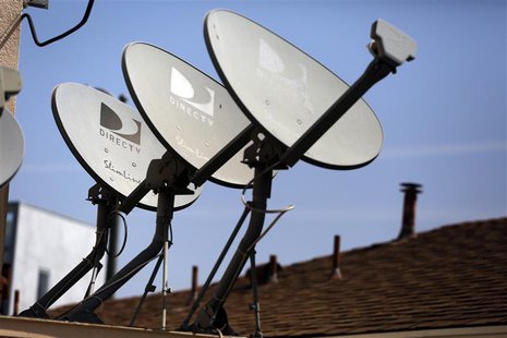 DirecTV satellite dishes are seen on an apartment roof in Los Angeles, California May 18, 2014. tes. REUTERS/Jonathan Alcorn DirecTV satellite dishes are seen on an apartment roof in Los Angeles, California May 18, 2014. tes. REUTERS/Jonathan Alcorn