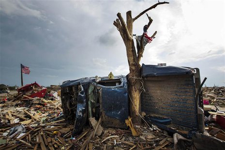 A wreckage of a pickup truck is wrapped around a tree trunk after being thrown there by by a tornado in Moore, Oklahoma in this May 25, 2013 A wreckage of a pickup truck is wrapped around a tree trunk after being thrown there by by a tornado in Moore, Oklahoma in this May 25, 2013