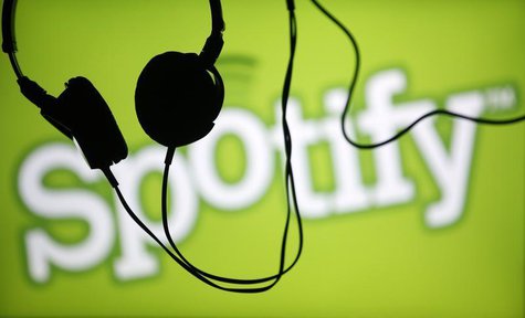Headsets hang in front of a screen displaying a Spotify logo on it, in Zenica February 20, 2014. REUTERS/Dado Ruvic Headsets hang in front of a screen displaying a Spotify logo on it, in Zenica February 20, 2014. REUTERS/Dado Ruvic