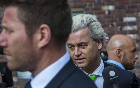 Far-right politician Geert Wilders of the anti-immigration Dutch Freedom (PVV) Party (C), flanked by two bodyguards, speaks to the media aft Far-right politician Geert Wilders of the anti-immigration Dutch Freedom (PVV) Party (C), flanked by two bodyguards, speaks to the media aft