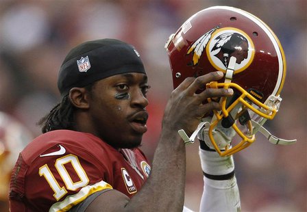 Washington Redskins quarterback Robert Griffin III puts his helmet back on after being tackled by the Baltimore Ravens defense in the first Washington Redskins quarterback Robert Griffin III puts his helmet back on after being tackled by the Baltimore Ravens defense in the first