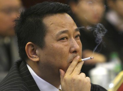 Liu Han, former chairman of Hanlong Mining, smokes a cigarette during a conference in Mianyang, Sichuan province, in this picture taken Marc Liu Han, former chairman of Hanlong Mining, smokes a cigarette during a conference in Mianyang, Sichuan province, in this picture taken Marc