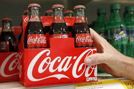 An employee arranges bottles of Coca-Cola at a store in Alexandria, Virginia October 16, 2012. REUTERS/Kevin Lamarque An employee arranges bottles of Coca-Cola at a store in Alexandria, Virginia October 16, 2012. REUTERS/Kevin Lamarque