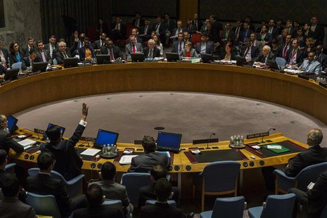 Russia's UN Ambassador Vitaly Churkin (top, arm raised) and China's deputy U.N. Ambassador Wang Min vote in the United Nations Security Coun Russia's UN Ambassador Vitaly Churkin (top, arm raised) and China's deputy U.N. Ambassador Wang Min vote in the United Nations Security Coun