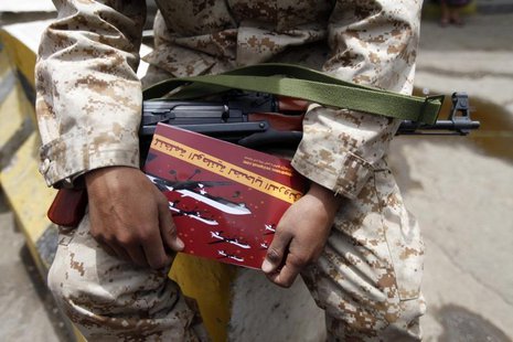 A soldier carries an anti-U.S. drone booklet as people chant slogans against U.S. drone strikes outside the Yemeni House of Representatives A soldier carries an anti-U.S. drone booklet as people chant slogans against U.S. drone strikes outside the Yemeni House of Representatives