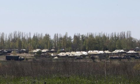 Russian military vehicles and army tents are seen in a field outside the village of Severny in Belgorod region near the Russian-Ukrainian bo Russian military vehicles and army tents are seen in a field outside the village of Severny in Belgorod region near the Russian-Ukrainian bo