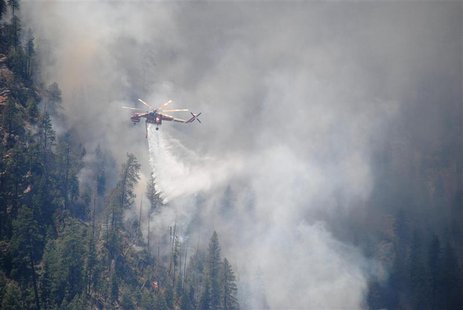 A water-dropping helicopter makes its delivery at the Slide Fire in Oak Tree Canyon near Sedona, Arizona in this May 22, 2014 handout photo A water-dropping helicopter makes its delivery at the Slide Fire in Oak Tree Canyon near Sedona, Arizona in this May 22, 2014 handout photo