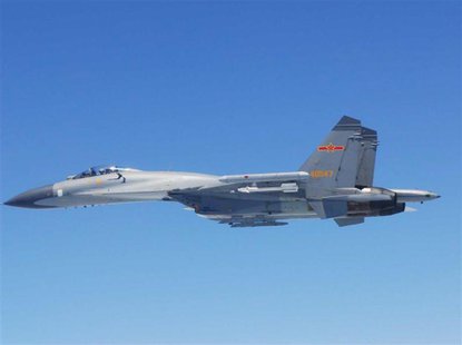 A Chinese SU-27 fighter flies over the East China Sea, in this handout photo taken May 24, 2014 and released by the Defense Ministry of Japa A Chinese SU-27 fighter flies over the East China Sea, in this handout photo taken May 24, 2014 and released by the Defense Ministry of Japa