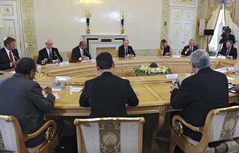 Russia's President Vladimir Putin (C, facing the camera) meets with a group of foreign journalists on the sidelines of the St. Petersburg In Russia's President Vladimir Putin (C, facing the camera) meets with a group of foreign journalists on the sidelines of the St. Petersburg In