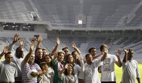 Brazil's President Dilma Rousseff (C) poses with workers as she visits the Arena da Baixada stadium in Curitiba May 9, 2014. REUTERS/Rodolfo Brazil's President Dilma Rousseff (C) poses with workers as she visits the Arena da Baixada stadium in Curitiba May 9, 2014. REUTERS/Rodolfo