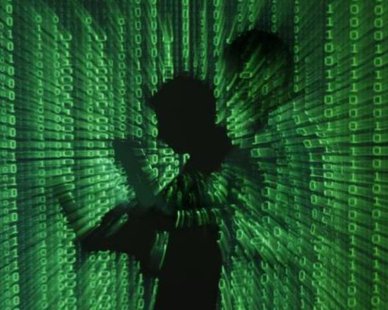 An illustration picture shows a projection of binary code on a man holding a laptop computer, in an office in Warsaw June 24, 2013. REUTERS/KACPER PEMPEL An illustration picture shows a projection of binary code on a man holding a laptop computer, in an office in Warsaw June 24, 2013. REUTERS/KACPER PEMPEL