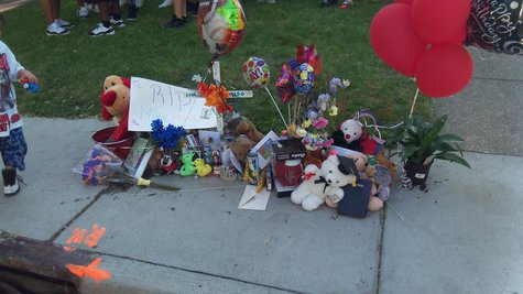 Orange Paint on the curb marks the location the youngster fell, and where a temporary memorial has been placed. Orange Paint on the curb marks the location the youngster fell, and where a temporary memorial has been placed.