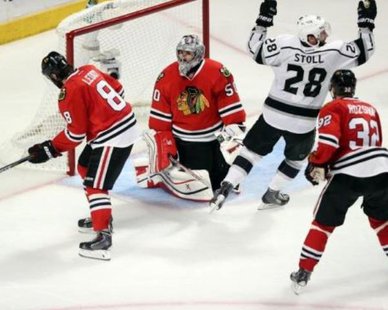 Jun 1, 2014; Chicago, IL, USA; Los Angeles Kings center Jarret Stoll (28) reacts after teammate Alec Martinez (not pictured) scored the game-winning goal past Chicago Blackhawks defenseman Nick Leddy (8) , defenseman Michal Rozsival (32) and goalie Corey Crawford (50) during the overtime period in game seven of the Western Conference Final of the 2014 Stanley Cup Playoffs at United Center. (Dennis Wierzbicki-USA TODAY Sports) Jun 1, 2014; Chicago, IL, USA; Los Angeles Kings center Jarret Stoll (28) reacts after teammate Alec Martinez (not pictured) scored the game-winning goal past Chicago Blackhawks defenseman Nick Leddy (8) , defenseman Michal Rozsival (32) and goalie Corey Crawford (50) during the overtime period in game seven of the Western Conference Final of the 2014 Stanley Cup Playoffs at United Center. (Dennis Wierzbicki-USA TODAY Sports)