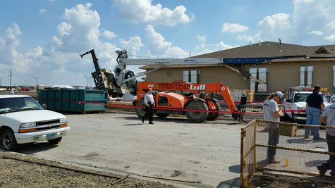 Crane tips on funeral home building under construction in West Fargo Crane tips on funeral home building under construction in West Fargo