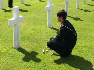 A member of the band visits the grave of a soldier from Michigan. A member of the band visits the grave of a soldier from Michigan.