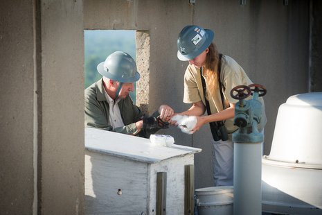 John Castrale, nongame bird biologist for Indiana Department of Natural Resources Division of Fish and Wildlife, and his assistant, Amy Kearns, remove on May 28, a peregrine falcon chick from the nest box on the rooftop of Indiana State University’s now vacant Statesman Towers. John Castrale, nongame bird biologist for Indiana Department of Natural Resources Division of Fish and Wildlife, and his assistant, Amy Kearns, remove on May 28, a peregrine falcon chick from the nest box on the rooftop of Indiana State University’s now vacant Statesman Towers.