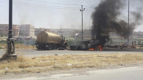Burning vehicles belonging to Iraqi security forces are seen during clashes between Iraqi security forces and al Qaeda-linked Islamic State in Iraq and the Levant (ISIL) in the northern Iraq city of Mosul, June 10, 2014.
CREDIT: REUTERS/STRINGER Burning vehicles belonging to Iraqi security forces are seen during clashes between Iraqi security forces and al Qaeda-linked Islamic State in Iraq and the Levant (ISIL) in the northern Iraq city of Mosul, June 10, 2014.
CREDIT: REUTERS/STRINGER