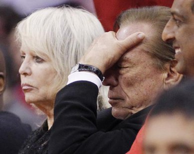 Los Angeles Clippers owner Donald Sterling (R) puts his hand over his face as he sits courtside with his wife Shelly (L) while the Clippers trail the Chicago Bulls in the second half of their NBA basketball game in Los Angeles in this December 30, 2011 file photo.
CREDIT: REUTERS/DANNY MOLOSHOK/FILES Los Angeles Clippers owner Donald Sterling (R) puts his hand over his face as he sits courtside with his wife Shelly (L) while the Clippers trail the Chicago Bulls in the second half of their NBA basketball game in Los Angeles in this December 30, 2011 file photo.
CREDIT: REUTERS/DANNY MOLOSHOK/FILES