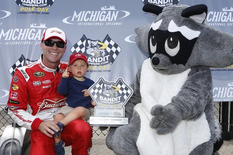 NASCAR Sprint Cup Series driver Kevin Harvick celebrates his 204.557 mph winning pole speed at Michigan International Speedway on June 13, 2014, with his son Keelan and the Bandit Chippers bandit. Photo by: LAT USA. NASCAR Sprint Cup Series driver Kevin Harvick celebrates his 204.557 mph winning pole speed at Michigan International Speedway on June 13, 2014, with his son Keelan and the Bandit Chippers bandit. Photo by: LAT USA.