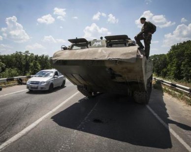 A pro-Russian separatist looks on from an amphibious vehicle near a road check point outside the eastern Ukrainian city of Luhansk June 8, 2014. REUTERS/SHAMIL ZHUMATOV A pro-Russian separatist looks on from an amphibious vehicle near a road check point outside the eastern Ukrainian city of Luhansk June 8, 2014. REUTERS/SHAMIL ZHUMATOV