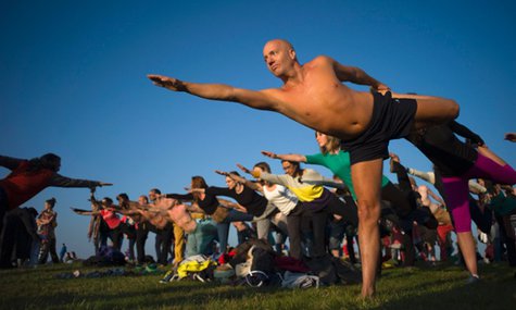 Stonehenge summer solstice 2014 Visitors gather for some yoga to greet the sun at Stonlamber for the best vantage point … Photograph: Kieran Doherty/Reuters
Stonehenge summer solstice 2014 Visitors gather for some yoga to greet the sun at Stonlamber for the best vantage point … Photograph: Kieran Doherty/Reuters