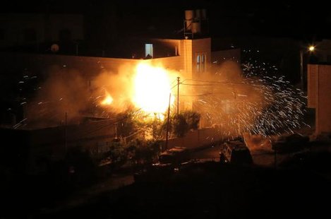 Flames are seen after a blast on the top floor of the family home of an alleged abductor in the West Bank City of Hebron July 1, 2014. REUTERS/Ammar Awad Flames are seen after a blast on the top floor of the family home of an alleged abductor in the West Bank City of Hebron July 1, 2014. REUTERS/Ammar Awad