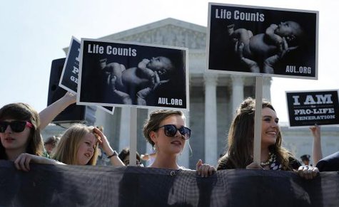 Anti-abortion demonstrators wait for the U.S. Supreme Court ruling in the Hobby Lobby case to be announced in Washington June 30, 2014.
CREDIT: REUTERS/JONATHAN ERNST Anti-abortion demonstrators wait for the U.S. Supreme Court ruling in the Hobby Lobby case to be announced in Washington June 30, 2014.
CREDIT: REUTERS/JONATHAN ERNST