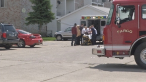 Medical personnel attending to a boy who fell off a 2nd floor balcony in south Fargo Medical personnel attending to a boy who fell off a 2nd floor balcony in south Fargo