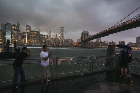 Tourists stand underneath the Brooklyn Bridge to photograph a summer storm bearing down on New York July 2, 2014.
CREDIT: REUTERS/LUCAS JACKSON Tourists stand underneath the Brooklyn Bridge to photograph a summer storm bearing down on New York July 2, 2014.
CREDIT: REUTERS/LUCAS JACKSON