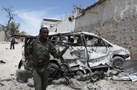 A Somali government soldier walks next to a car damaged in an explosion near Al Mukaram Hotel in Mogadishu March 15, 2014.
CREDIT: REUTERS/OMAR FARUK A Somali government soldier walks next to a car damaged in an explosion near Al Mukaram Hotel in Mogadishu March 15, 2014.
CREDIT: REUTERS/OMAR FARUK