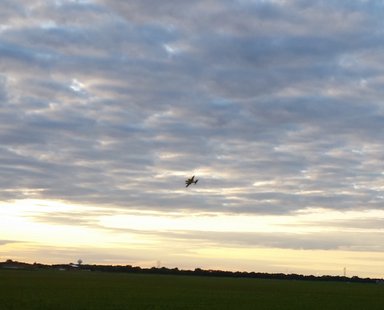An airplane spraying mosquitoes over the F-M area An airplane spraying mosquitoes over the F-M area