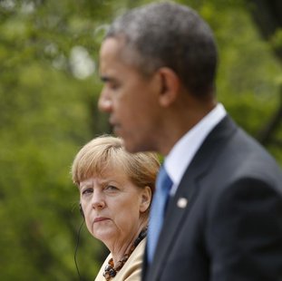 German Chancellor Angela Merkel listens to President Barack Obama address a joint news conference in the Rose Garden of the White House in Washington. REUTERS/Kevin Lamarque German Chancellor Angela Merkel listens to President Barack Obama address a joint news conference in the Rose Garden of the White House in Washington. REUTERS/Kevin Lamarque