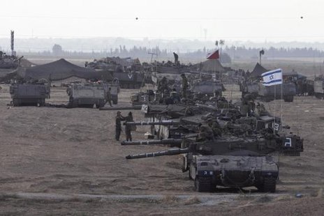 Israeli tanks and armoured personnel carriers (APCs) are seen at a staging area outside the central Gaza Strip July 15, 2014. Credit: Reuters/Baz Ratner Israeli tanks and armoured personnel carriers (APCs) are seen at a staging area outside the central Gaza Strip July 15, 2014. Credit: Reuters/Baz Ratner