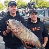 Josh Teunis with fishing buddy Bill Kimball on the right and his record catch.
(photo courtesy DNR). Josh Teunis with fishing buddy Bill Kimball on the right and his record catch.
(photo courtesy DNR).